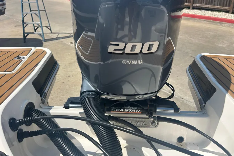 Slide: The Image of Interior of 2016 Chaparral 230 Suncoast boat with stereo system and chrome handle. - 22