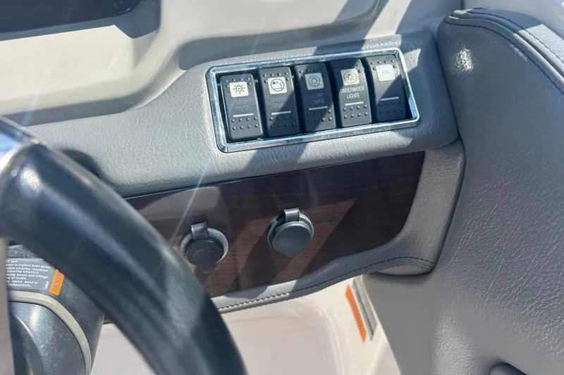 Slide: The Image of Control panel of a 2016 Chaparral 230 Suncoast boat with switches and ignition. - 24