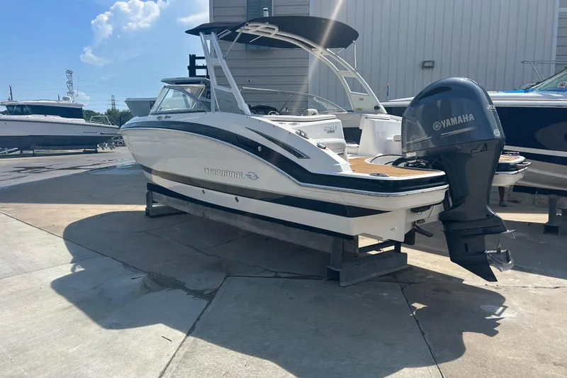 Slide: The Image of 2016 Chaparral 230 Suncoast boat with Yamaha 200 engine, docked outdoors. - 4