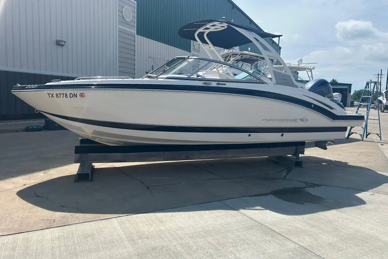 Slide: The Image of 2016 Chaparral 230 Suncoast boat with Yamaha engine on display outdoors. - 5
