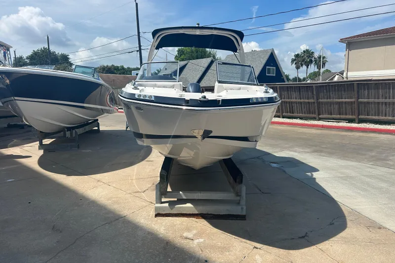 Slide: The Image of 2016 Chaparral 230 Suncoast boat on trailer, parked outdoors. - 6
