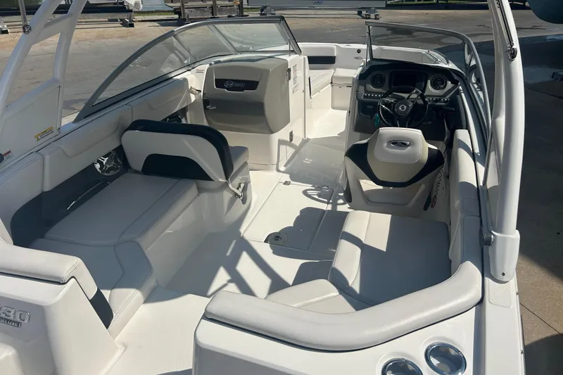 Slide: The Image of 2016 Chaparral 230 Suncoast boat on display in a sunny outdoor setting. - 7
