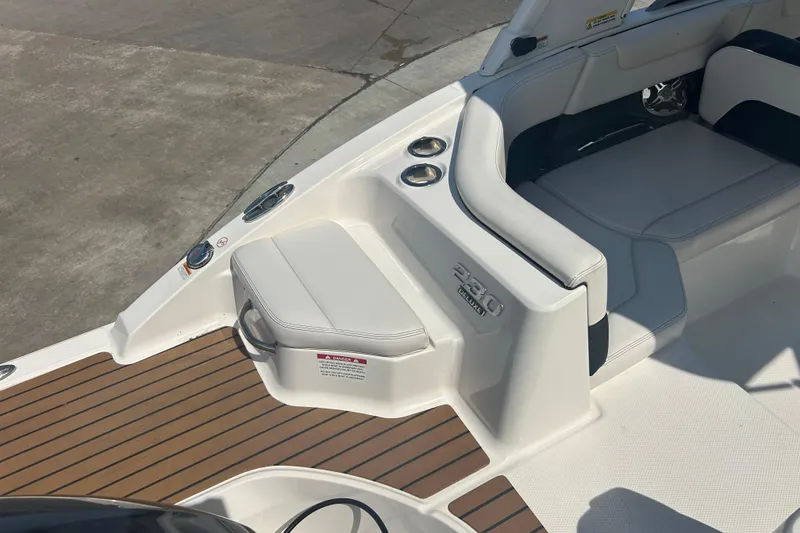 Slide: The Image of 2016 Chaparral 230 Suncoast boat interior with seating and steering console. - 8