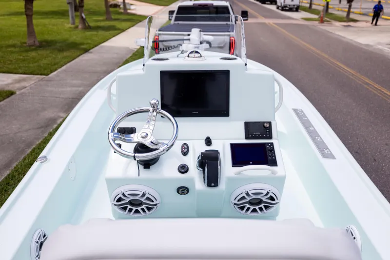 Slide: The Image of 2024 Yellowfin 24 CE boat dashboard with steering wheel and electronic displays. - 14