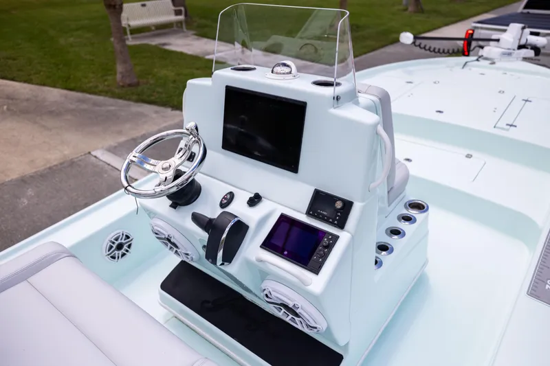 Slide: The Image of 2024 Yellowfin 24 CE boat console with steering wheel and electronic displays. - 15