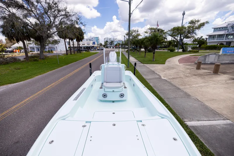 Slide: The Image of 2024 Yellowfin 24 CE boat on a road, showcasing sleek design and spacious deck. - 17