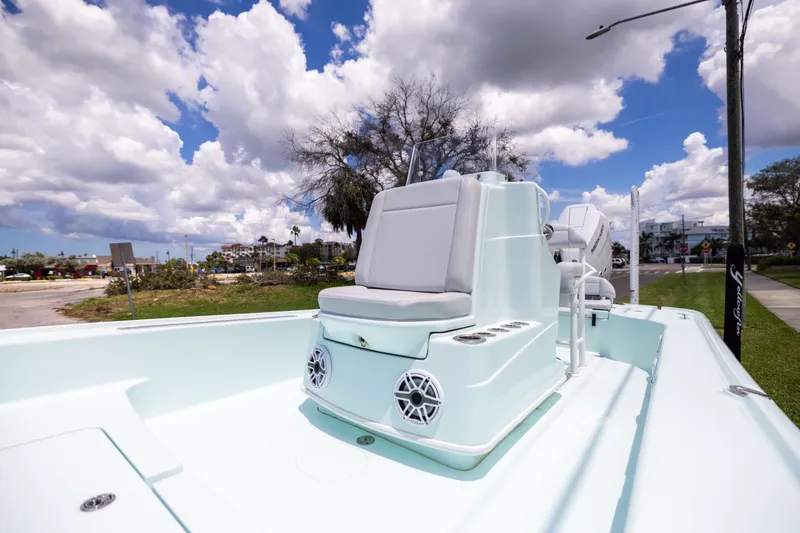 Slide: The Image of 2024 Yellowfin 24 CE boat with sleek seating and modern design under a cloudy sky. - 19