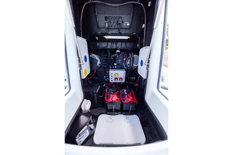 Slide: The Image of 2024 Yellowfin 24 CE boat interior showing electrical components and battery setup. - 24