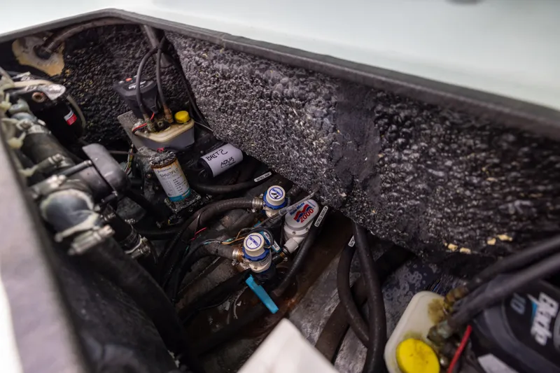 Slide: The Image of 2024 Yellowfin 24 CE boat engine compartment with wiring and components. - 26