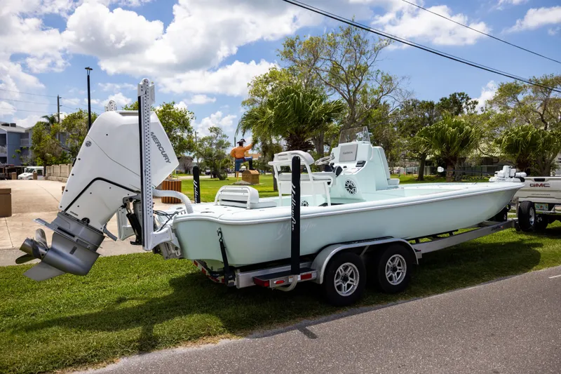 Slide: The Image of 2024 Yellowfin 24 CE boat on trailer, parked outdoors under a sunny sky. - 4