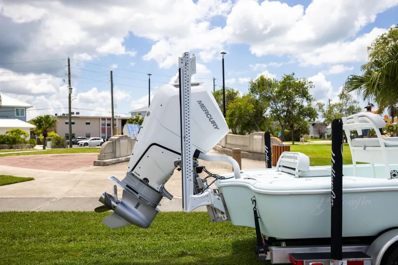 Slide: The Image of 2024 Yellowfin 24 CE boat with Mercury outboard motor on trailer, parked outdoors. - 5