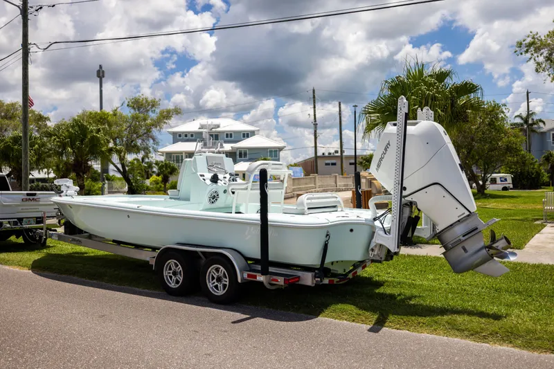 Slide: The Image of 2024 Yellowfin 24 CE boat on trailer, parked outdoors under cloudy sky. - 8