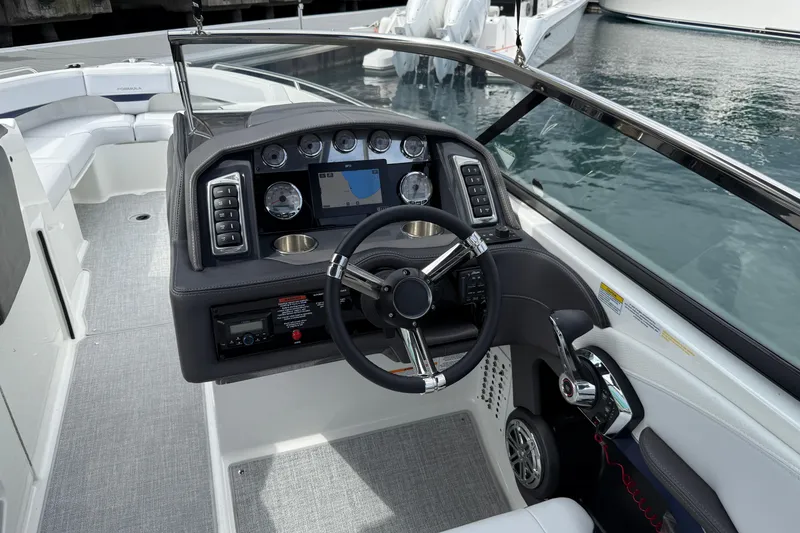 Slide: The Image of 2024 Formula 270 Bowrider dashboard with modern controls and sleek steering wheel design. - 11