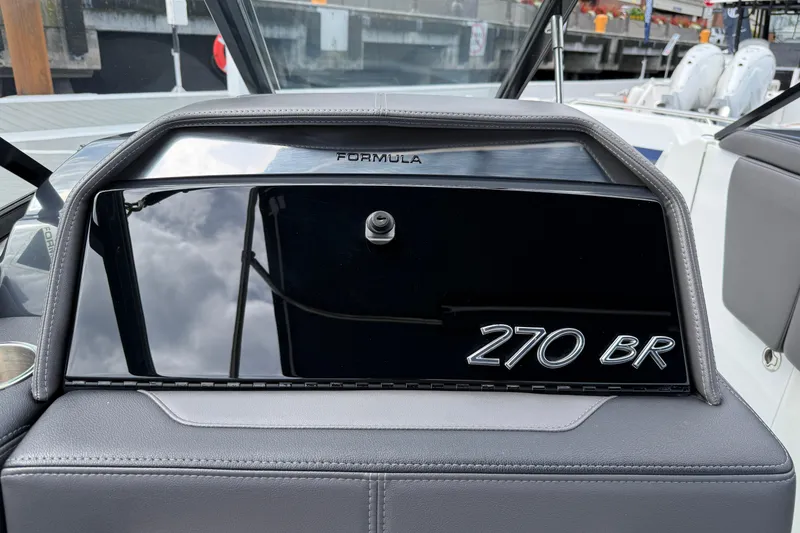 Slide: The Image of 2024 Formula 270 Bowrider dashboard with sleek black panel and logo. - 16
