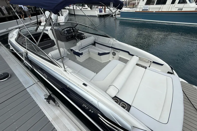Slide: The Image of 2024 Formula 270 Bowrider boat docked, featuring spacious seating and sleek design. - 6