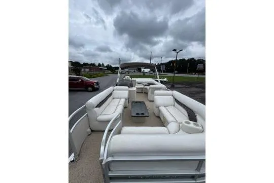 Slide: The Image of 2006 Premier 225 Legend pontoon boat with spacious seating under cloudy skies. - 5