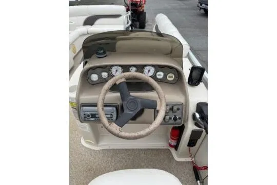 Slide: The Image of 2006 Premier 225 Legend boat dashboard with steering wheel and gauges. - 9