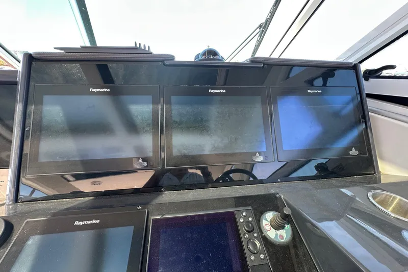 Slide: The Image of 2017 Formula 430 Super Sport Crossover boat on calm water under clear blue sky. - 12