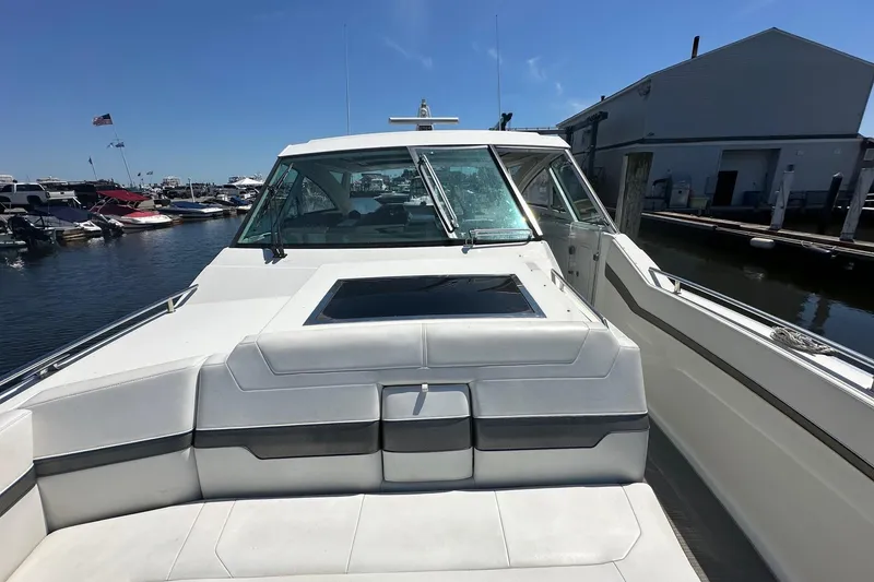 Slide: The Image of 2017 Formula 430 Super Sport Crossover interior with plush seating and marina view. - 22