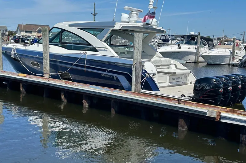 Slide: The Image of 2017 Formula 430 Super Sport Crossover boat on water, blue and white design. - 3
