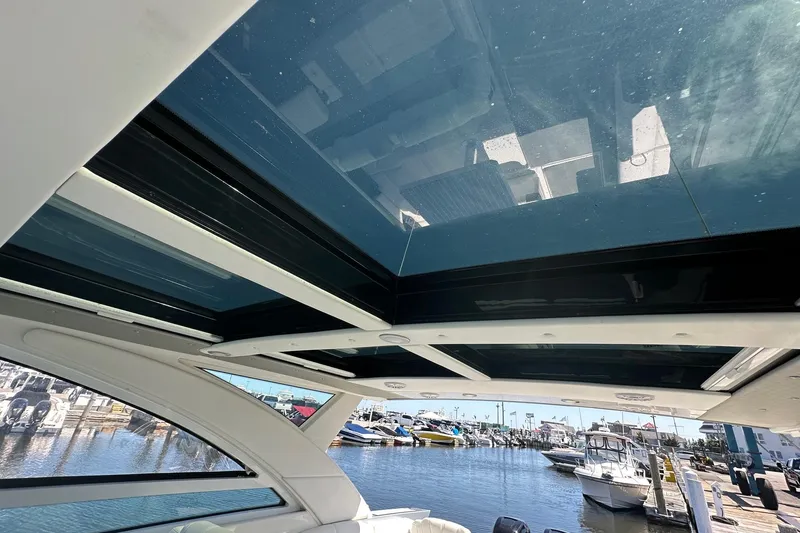 Slide: The Image of 2017 Formula 430 Super Sport Crossover boat docked at marina under clear blue sky. - 31