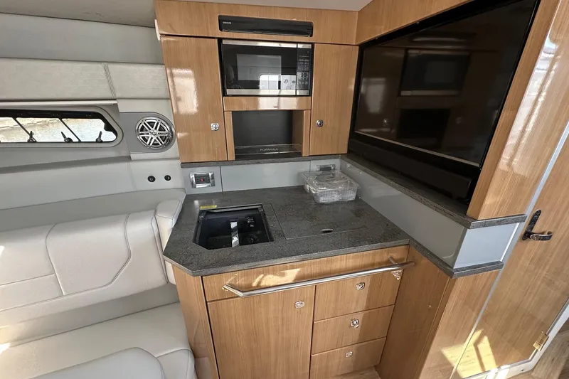 Slide: The Image of 2017 Formula 430 Super Sport Crossover interior with kitchenette and seating area. - 36