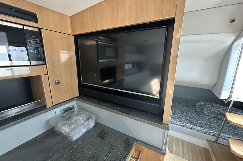 Slide: The Image of Interior of 2017 Formula 430 Super Sport Crossover with TV, microwave, and bed. - 37