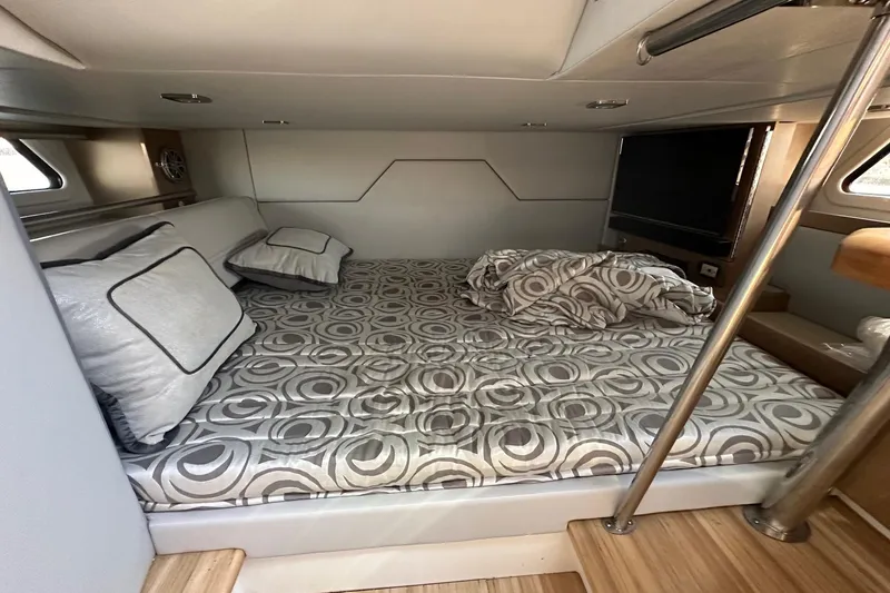 Slide: The Image of 2017 Formula 430 Super Sport Crossover cabin with patterned bedding and pillows. - 43
