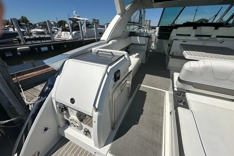 Slide: The Image of 2017 Formula 430 Super Sport Crossover yacht interior with seating and dock view. - 48