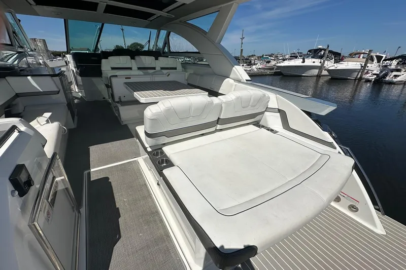 Slide: The Image of 2017 Formula 430 Super Sport Crossover boat on calm water, clear blue sky. - 6