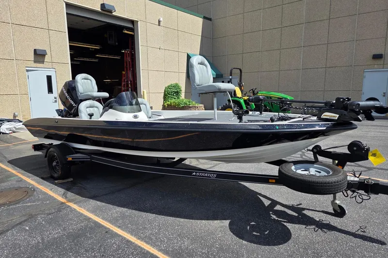 Slide: The Image of 2011 Stratos 186XT boat on trailer, parked outside a building. - 3