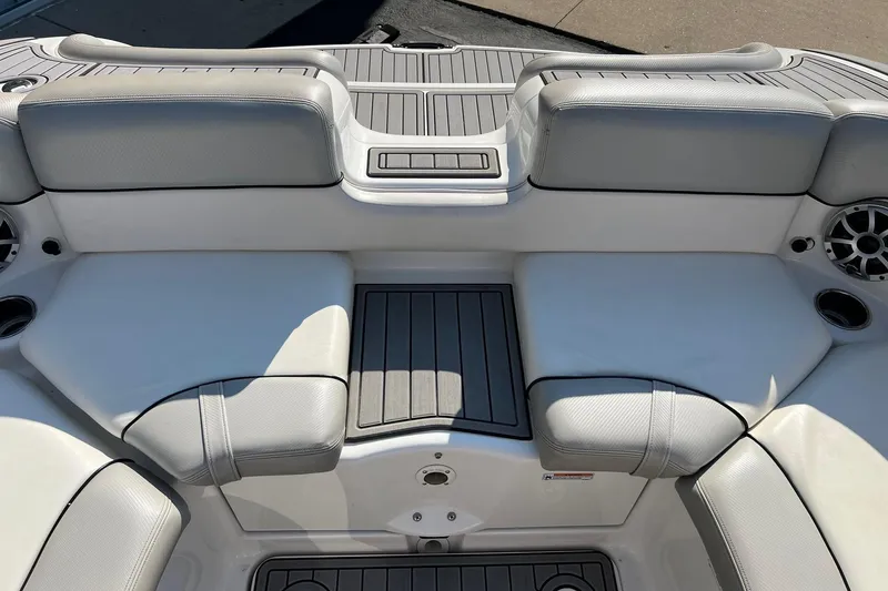 Slide: The Image of 2011 Yamaha Boats AR240 HO interior seating with gray upholstery and integrated speakers. - 15