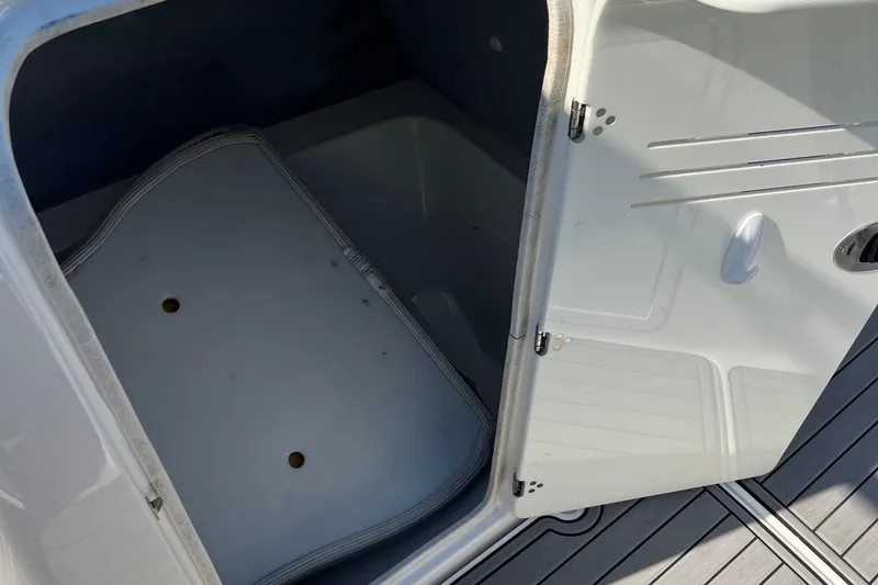 Slide: The Image of Open storage compartment on a 2011 Yamaha Boats AR240 HO. - 18