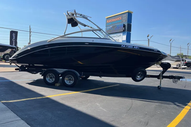 Slide: The Image of 2011 Yamaha Boats AR240 HO on trailer at a dealership parking lot. - 6