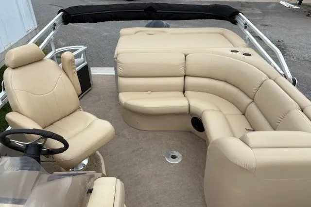 Slide: The Image of 2008 Bennington 2275QXi boat interior with beige seating and steering wheel. - 7