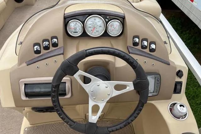 Slide: The Image of 2008 Bennington 2275QXi boat dashboard with steering wheel and gauges. - 8