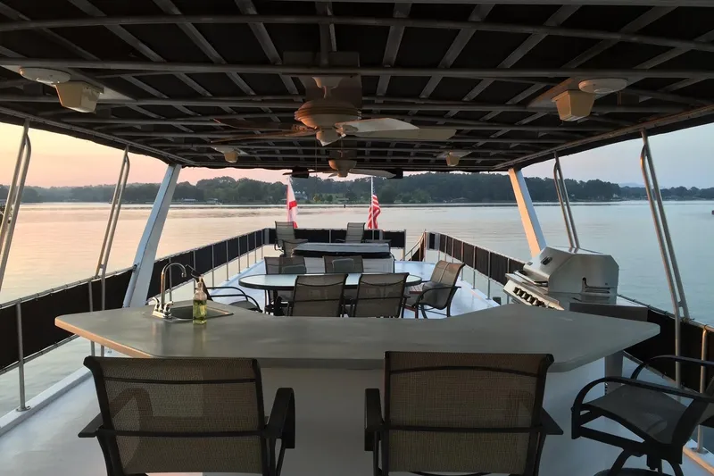 Slide: The Image of 1998 Sumerset 16x80 houseboat deck with seating, grill, and scenic lake view. - 10