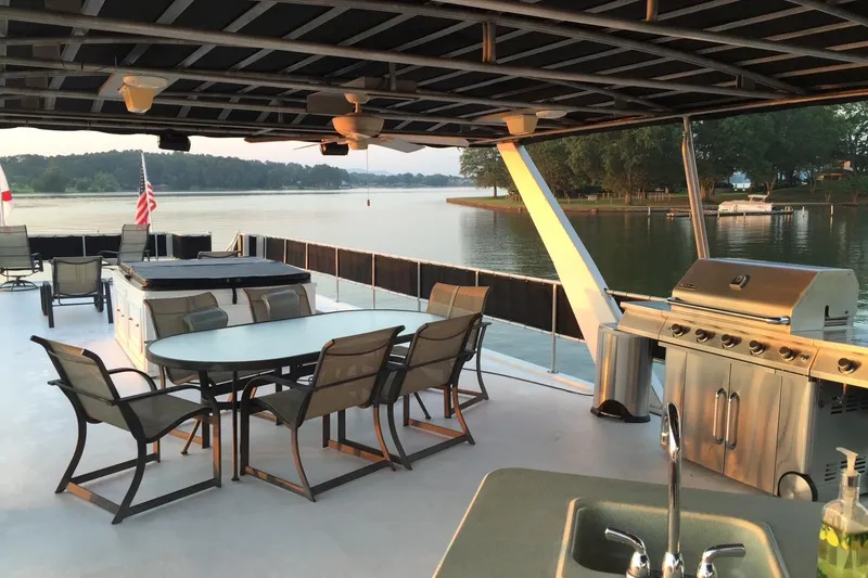 Slide: The Image of Luxurious 1998 Sumerset 16x80 houseboat deck with dining area, grill, and scenic lake view. - 11