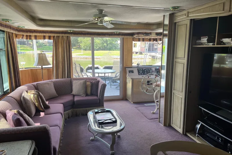 Slide: The Image of Interior of a 1998 Sumerset 16x80 houseboat with cozy seating and lake view. - 2