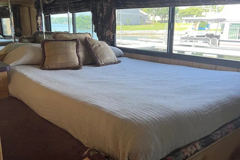Slide: The Image of Cozy bedroom interior in a 1998 Sumerset 16x80 houseboat with large window view. - 5