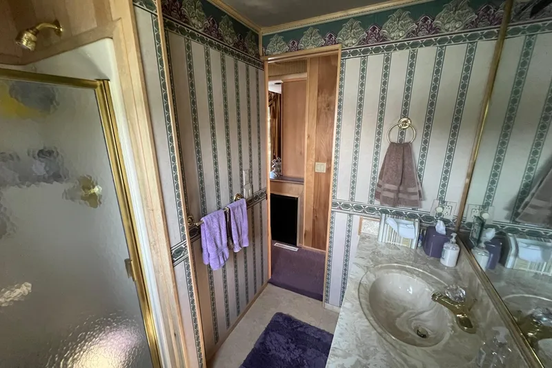 Slide: The Image of Bathroom interior of 1998 Sumerset 16x80 houseboat with vintage decor and fixtures. - 7