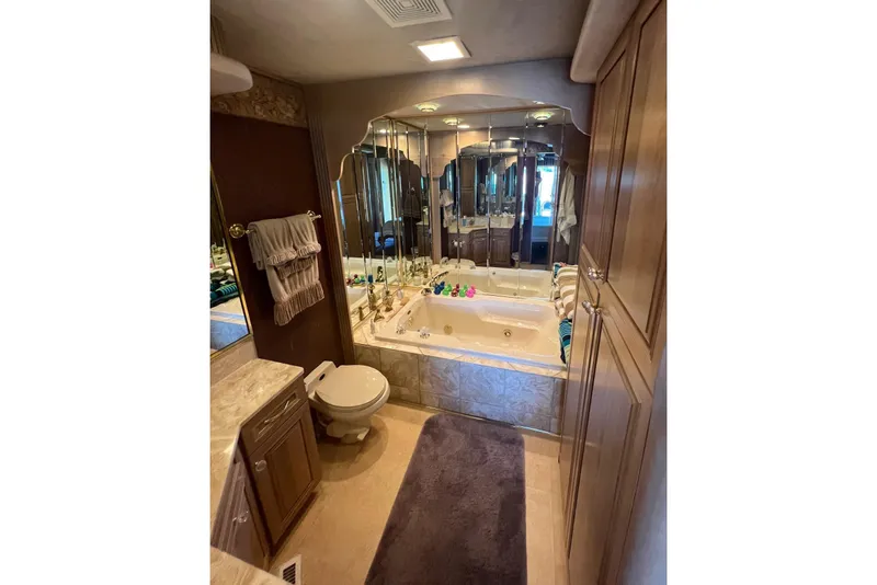 Slide: The Image of Luxurious bathroom in 1998 Sumerset 16x80 houseboat with mirrored walls and jacuzzi tub. - 9