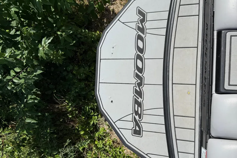 Slide: The Image of 2019 Moomba Craz boat deck with logo, surrounded by lush greenery. - 10