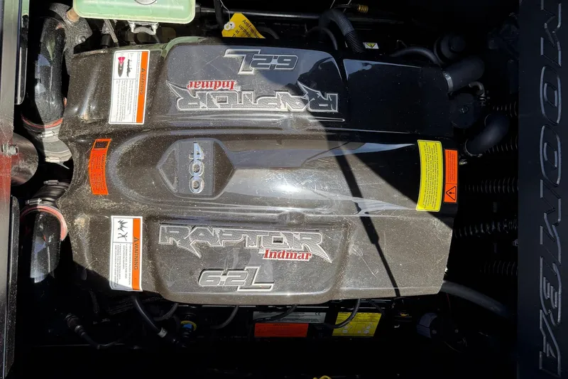 Slide: The Image of 2019 Moomba Craz engine, Raptor 6.2L, detailed view with warning labels. - 11