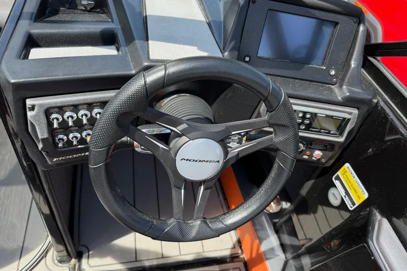 Slide: The Image of Steering wheel and dashboard of a 2019 Moomba Craz boat. - 7