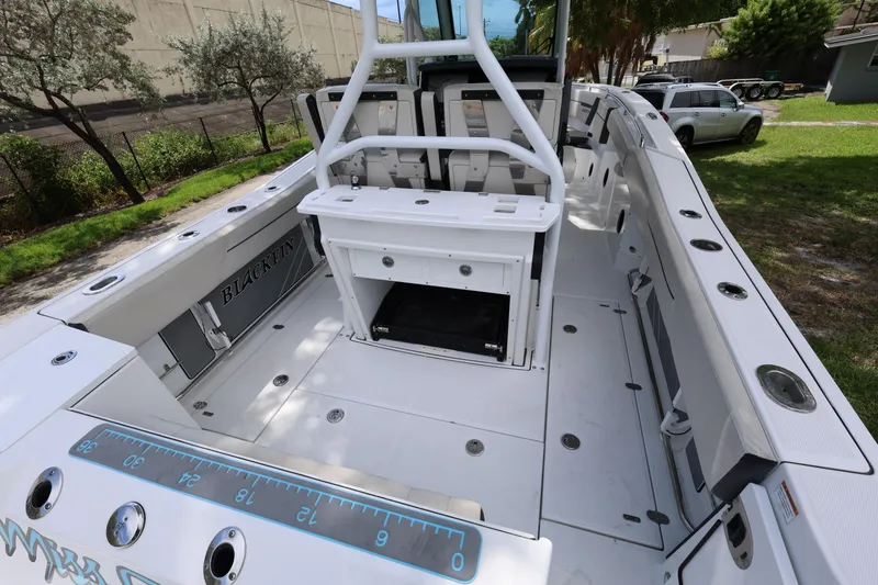 Slide: The Image of 2021 Blackfin 272 CC boat interior with spacious deck and fishing rod holders. - 10