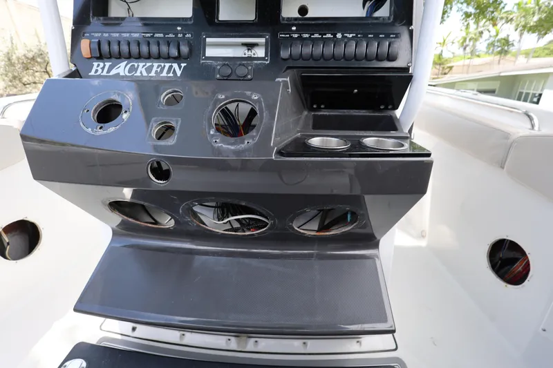Slide: The Image of 2021 Blackfin 272 CC boat console with cup holders and control panel. - 14