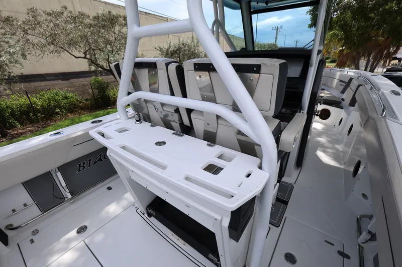 Slide: The Image of 2021 Blackfin 272 CC boat interior with seating and console, showcasing modern design. - 17