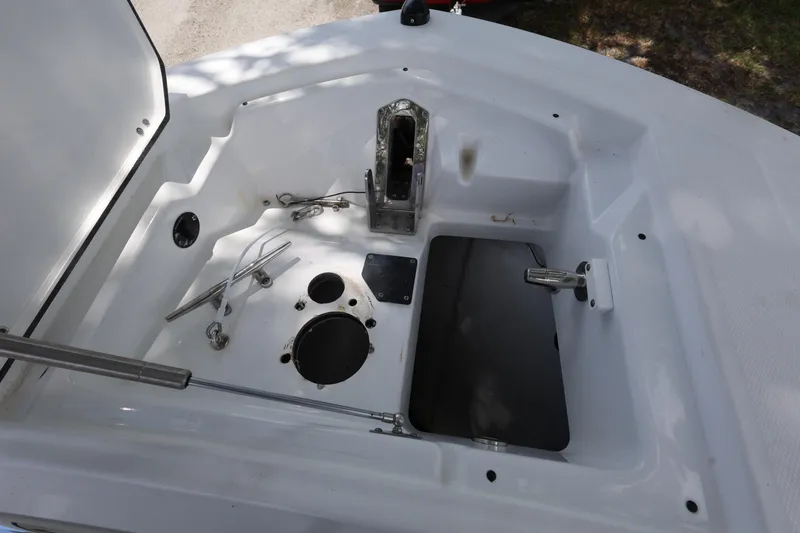 Slide: The Image of 2021 Blackfin 272 CC boat anchor storage compartment with open hatch and hardware. - 19