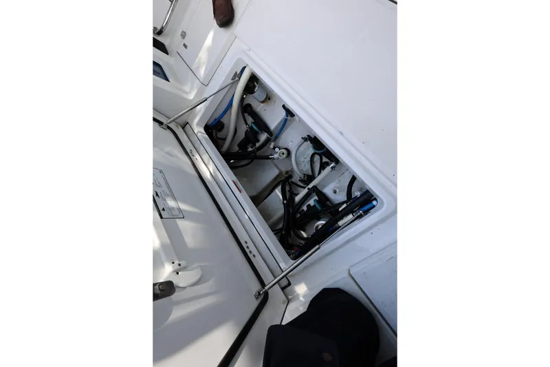 Slide: The Image of 2021 Blackfin 272 CC boat interior showing open hatch with visible wiring and components. - 20